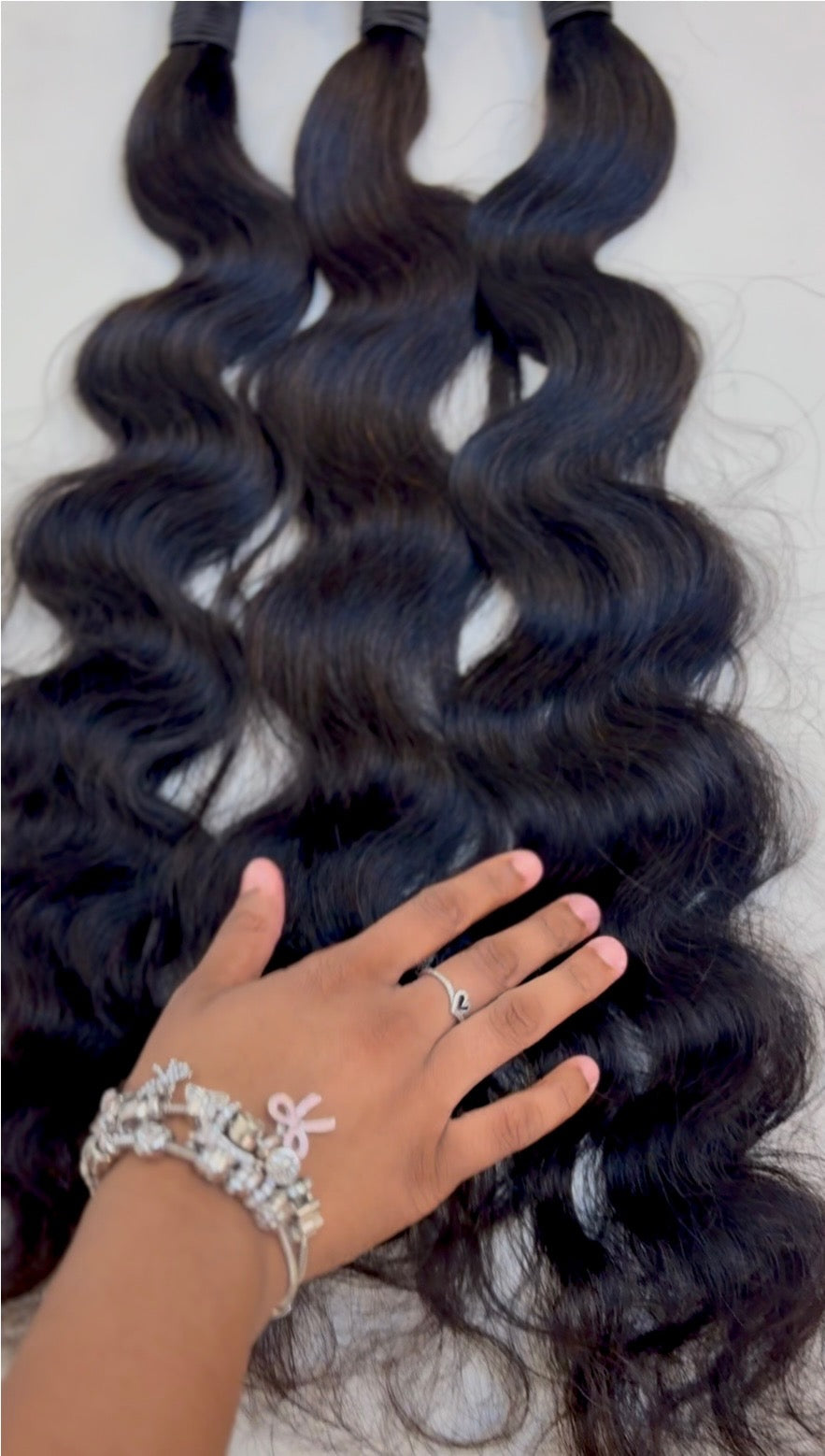 Three Gold Baddie Body Wave human hair bundles with soft flowing waves