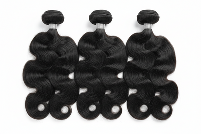 Three Platinum Body Wave human hair bundles with big soft flowing waves on a white background